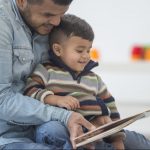 Father Reading His Son a Book